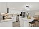 Modern kitchen with island, stainless steel appliances, and white cabinets at 7835 Wallaba Ln, New Port Richey, FL 34653