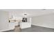 Modern kitchen with sleek gray floors, white cabinets, stainless steel appliances, and stylish island lighting at 7835 Wallaba Ln, New Port Richey, FL 34653