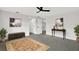 The spacious living room features updated floors, fresh paint, and a ceiling fan at 7835 Wallaba Ln, New Port Richey, FL 34653