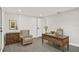 Bright home office featuring a wooden desk and comfortable seating at 7835 Wallaba Ln, New Port Richey, FL 34653