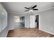 Bright room featuring vinyl floors, neutral walls, ceiling fan, and sliding glass doors to lanai at 8033 Norwich Dr, Port Richey, FL 34668