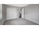 Bedroom features gray walls, neutral carpet, and a large closet for storage at 8033 Norwich Dr, Port Richey, FL 34668