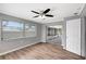 Bright room featuring vinyl floors, neutral walls, ceiling fan, and sliding glass doors to lanai at 8033 Norwich Dr, Port Richey, FL 34668