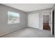 Bedroom features gray walls, neutral carpet and a closet for storage at 8033 Norwich Dr, Port Richey, FL 34668