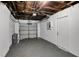Spacious garage featuring an automatic door, epoxy floor, and ample storage space at 8033 Norwich Dr, Port Richey, FL 34668