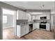 Bright kitchen features white cabinets, granite countertops and stainless steel appliances at 8033 Norwich Dr, Port Richey, FL 34668