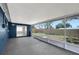 Screened-in lanai with epoxy floors offering a shaded outdoor space with view of fenced in yard at 8033 Norwich Dr, Port Richey, FL 34668