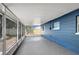 Screened-in lanai with epoxy floors offers a shaded outdoor space with view of fenced in yard at 8033 Norwich Dr, Port Richey, FL 34668