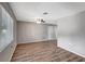 Spacious living room with wood-look floors, a modern ceiling fan, and neutral paint at 8033 Norwich Dr, Port Richey, FL 34668
