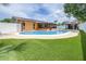 Beautiful backyard featuring a large pool, artificial turf, and covered gazebo at 8927 95Th N St, Seminole, FL 33777