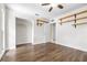 Bedroom with wood-look tile, a ceiling fan, built-in shelving, and closet at 8927 95Th N St, Seminole, FL 33777