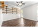 Bright bedroom featuring wood-look tile, modern shelving, and a ceiling fan at 8927 95Th N St, Seminole, FL 33777
