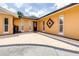 Inviting entrance featuring a decorative front door, brick-paved walkway, and well-manicured garden at 8927 95Th N St, Seminole, FL 33777