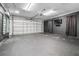 Spacious garage features a modern dark color, automatic door, and updated lighting fixtures at 8927 95Th N St, Seminole, FL 33777