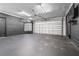 Well-lit garage with automatic door, fresh paint, and a sleek, modern aesthetic at 8927 95Th N St, Seminole, FL 33777