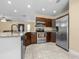 A kitchen with stainless steel appliances, granite countertops, tile floors and recessed lighting at 8927 95Th N St, Seminole, FL 33777