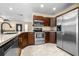 This kitchen has stainless steel appliances, granite countertops, recessed lighting and tile floors at 8927 95Th N St, Seminole, FL 33777