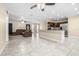 Open-concept living space with tile flooring, a comfortable brown couch, and a view into the kitchen and dining area at 8927 95Th N St, Seminole, FL 33777