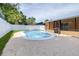 Backyard pool area with artificial grass and white fence offering a private outdoor oasis at 8927 95Th N St, Seminole, FL 33777