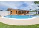 Beautiful swimming pool in backyard with covered lanai and artificial turf at 8927 95Th N St, Seminole, FL 33777