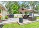 Backyard patio with outdoor seating, grill and well maintained lawn at 9016 Water Chestnut Dr, Temple Terrace, FL 33637