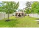 Large, grassy backyard with patio featuring an outdoor seating area at 9016 Water Chestnut Dr, Temple Terrace, FL 33637