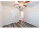Bedroom featuring wood-look floors, a ceiling fan, and closet doors at 9016 Water Chestnut Dr, Temple Terrace, FL 33637