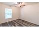 Bedroom featuring wood-look floors, a ceiling fan, and a window with exterior views at 9016 Water Chestnut Dr, Temple Terrace, FL 33637