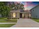 Charming single-story home with well-maintained lawn, landscaping, and a driveway leading to the garage at 9016 Water Chestnut Dr, Temple Terrace, FL 33637