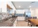 Bright kitchen featuring granite counters, white cabinets, stainless appliances, and tile floors at 9016 Water Chestnut Dr, Temple Terrace, FL 33637