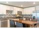 Updated kitchen featuring stainless steel appliances, a mosaic backsplash, and a wooden island at 9016 Water Chestnut Dr, Temple Terrace, FL 33637