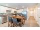 Bright kitchen with stainless appliances, white cabinets, tile backsplash, and an eat-in island at 9016 Water Chestnut Dr, Temple Terrace, FL 33637