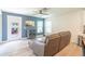 Living room with hardwood style floors, blue accent wall and outdoor view at 9016 Water Chestnut Dr, Temple Terrace, FL 33637