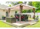 Outdoor patio with a seating area under a gazebo on a sunny day at 9016 Water Chestnut Dr, Temple Terrace, FL 33637