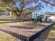 Neighborhood playground featuring swings, slides, and sitting area at 9016 Water Chestnut Dr, Temple Terrace, FL 33637