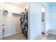 Organized walk-in closet with shelving and hanging space adjacent to the bathroom at 9016 Water Chestnut Dr, Temple Terrace, FL 33637
