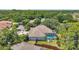 An aerial view of the back of the house featuring a pool, patio, and lush landscaping at 9202 Brindlewood Dr, Odessa, FL 33556