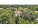 An aerial shot showcasing the home's backyard, solar panels and wooded surroundings at 9202 Brindlewood Dr, Odessa, FL 33556