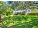 Expansive back yard featuring a screened pool area and mature landscaping at 9202 Brindlewood Dr, Odessa, FL 33556