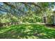 Large, well-maintained back yard with mature trees providing ample shade at 9202 Brindlewood Dr, Odessa, FL 33556