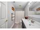 Bathroom features a vanity with decorative items and a shower with a curtain at 9202 Brindlewood Dr, Odessa, FL 33556