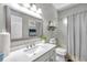 Well-lit bathroom with large framed mirror, quartz countertops, and shower/tub combination at 9202 Brindlewood Dr, Odessa, FL 33556