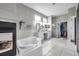 Bright bathroom features a soaking tub, walk-in shower, and double vanities with a large walk-in closet at 9202 Brindlewood Dr, Odessa, FL 33556