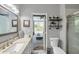 Bright bathroom with granite counters, modern fixtures, and view to the outdoor living area at 9202 Brindlewood Dr, Odessa, FL 33556