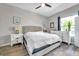 Serene bedroom with hardwood floors, neutral walls, and a large window at 9202 Brindlewood Dr, Odessa, FL 33556