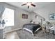 Cozy bedroom with grey rug, ceiling fan, and natural light, designed for comfort and relaxation at 9202 Brindlewood Dr, Odessa, FL 33556