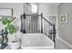 Entryway boasts staircase with black banister and view into another room at 9202 Brindlewood Dr, Odessa, FL 33556