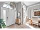 Bright foyer with high ceilings, tiled floor, and decorative chandelier, offering a warm welcome at 9202 Brindlewood Dr, Odessa, FL 33556