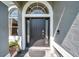 Inviting front door with sidelights and transom window, creating a grand entrance at 9202 Brindlewood Dr, Odessa, FL 33556
