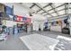 Spacious garage featuring ample storage solutions, sports memorabilia, and epoxy flooring at 9202 Brindlewood Dr, Odessa, FL 33556